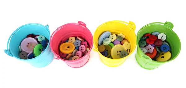 Botões coloridos em baldes isolados em branco — Fotografia de Stock