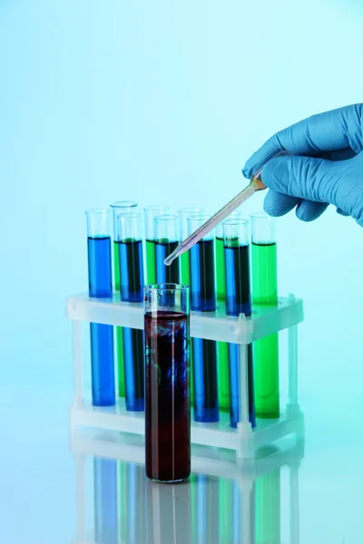 Test tubes on blue background — Stock Photo, Image