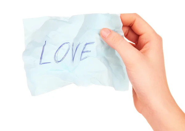 Liefde woord op stuk papier in hand geïsoleerd op wit — Stockfoto