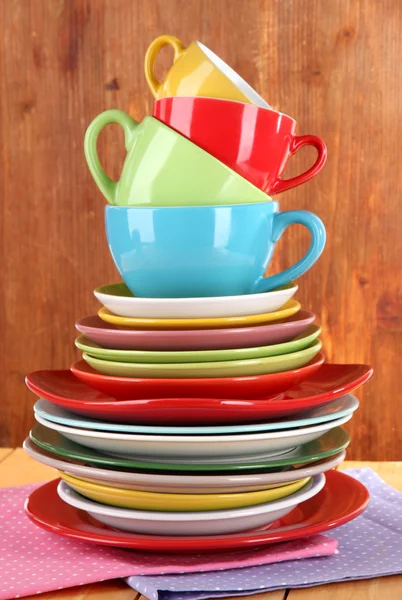 Mountain colorful dishes on napkin on wooden background — Stock Photo, Image
