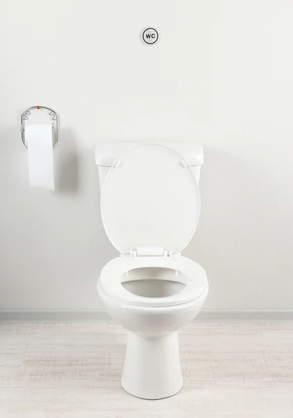 White toilet bowl and toilet paper in a bathroom — Stock Photo, Image