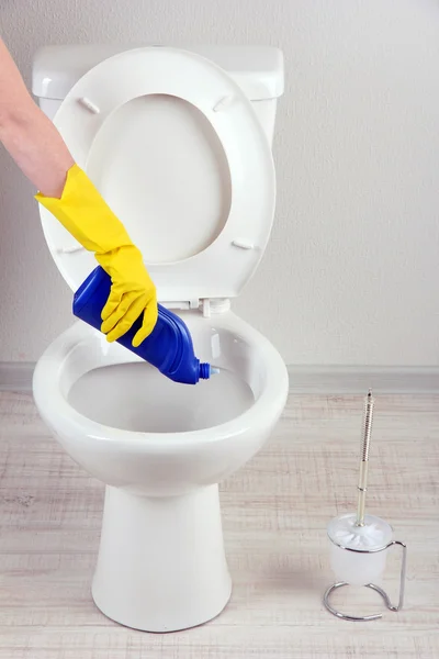 Frau Hand mit Sprühflasche reinigt Toilettenschüssel im Badezimmer — Stockfoto