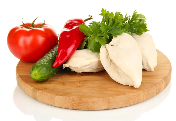 Boiled chicken breast on wooden cutting board with vegetables isolated on white — Stock Photo, Image