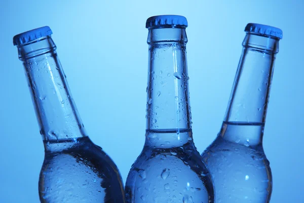 Water bottles on blue background — Stock Photo, Image