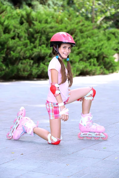 Little girl in roller skates at park — Stock Photo, Image