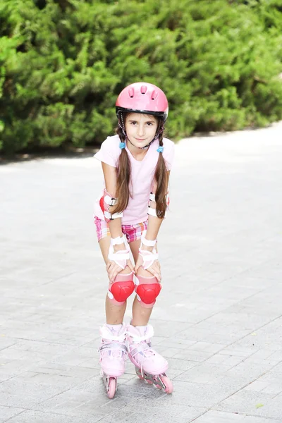 Little girl in roller skates at park Stock Picture