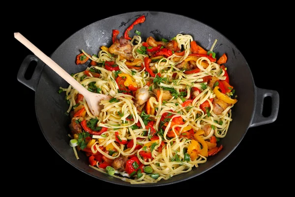 Noodles with vegetables on wok isolated on black — Stock Photo, Image