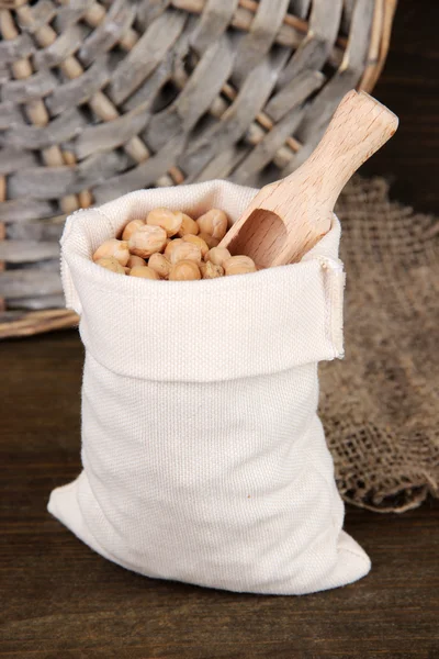 Beans in sack on wooden background — Stock Photo, Image