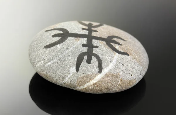 Fortune telling with symbols on stone on black background — Stock Photo, Image