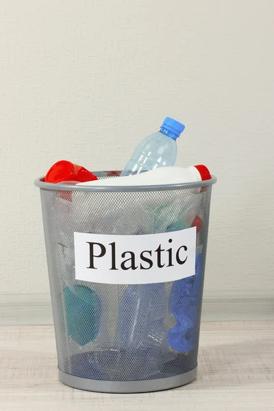 Assorted trash in bucket on room background — Stock Photo, Image