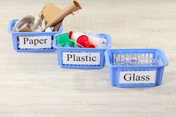 Three baskets of assorted debris on room background — Stock Photo, Image