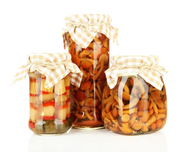 Delicious marinated mushrooms in glass jars, isolated on white — Stock Photo, Image