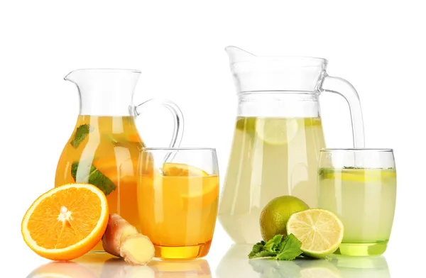 Orange and lemon lemonade in pitchers and glasses isolated on white — Stock Photo, Image