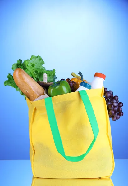 Eco bag with shopping on blue background — Stock Photo, Image
