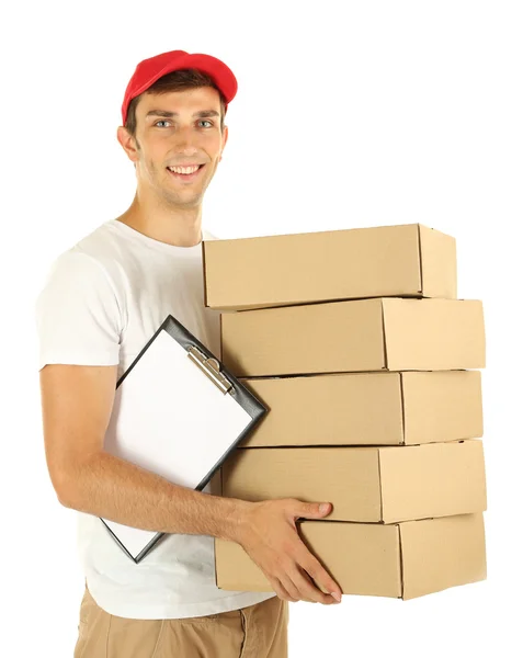 Young delivery man holding parcels and clipboard, isolated on white — Stock Photo, Image