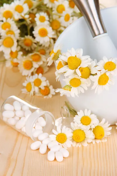 Medicine chamomile flowers on wooden table — Stock Photo, Image