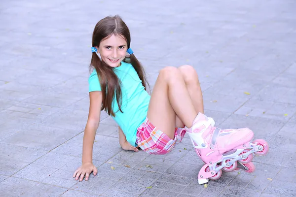 Kleines Mädchen auf Rollschuhen im Park — Stockfoto