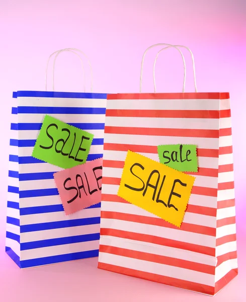 Striped bags on pink background — Stock Photo, Image