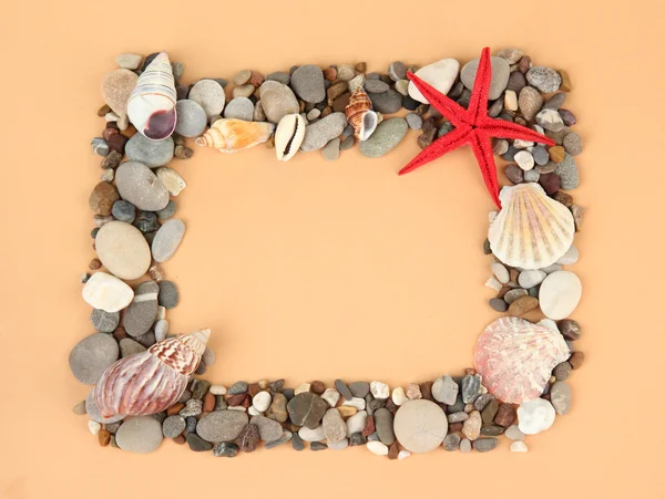 Frame of sea stones on color background — Stock Photo, Image