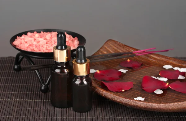 Spa composition with aroma oils on table on gray background — Stock Photo, Image
