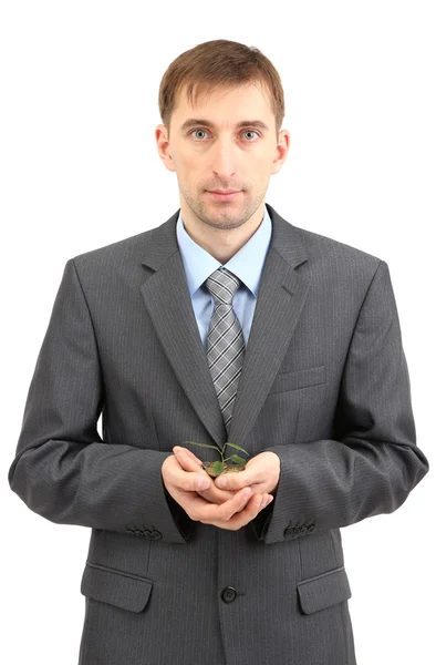 Young businessman with coins and plant isolated on whit — Stock Photo, Image