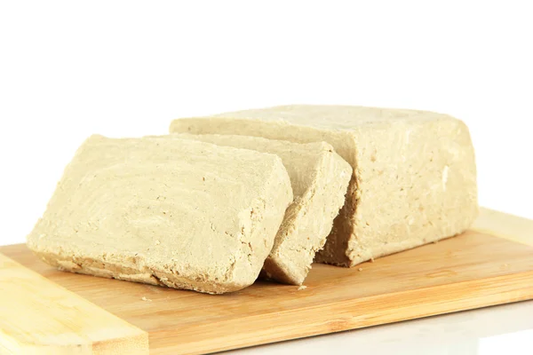 Tasty halva on cutting board isolated on white — Stock Photo, Image