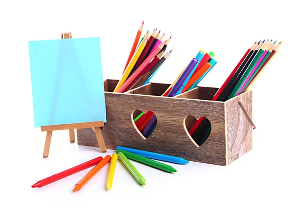 Different pencils in wooden crate and easel, isolated on white — Stock Photo, Image