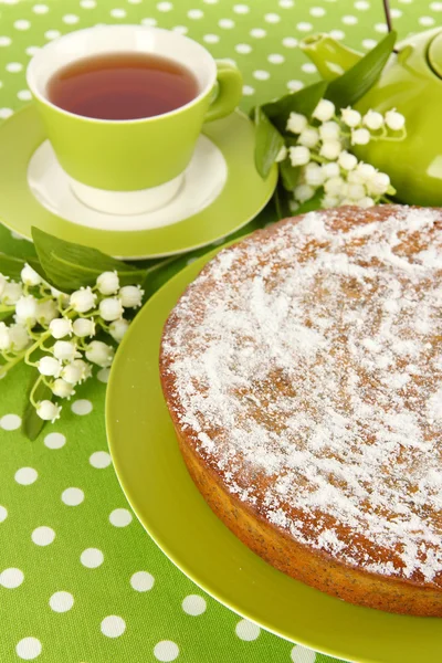 Delicious poppy seed cake with cup of tea on table close-up — Stock Photo, Image