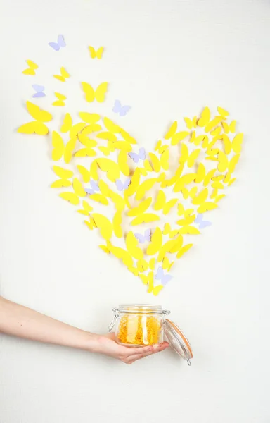 Paper yellow butterfly in form of heart fly out bank — Stock Photo, Image