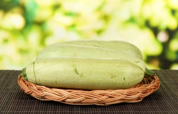 Fresh marrows on wicker, bamboo mat, on bright background — Stock Photo, Image