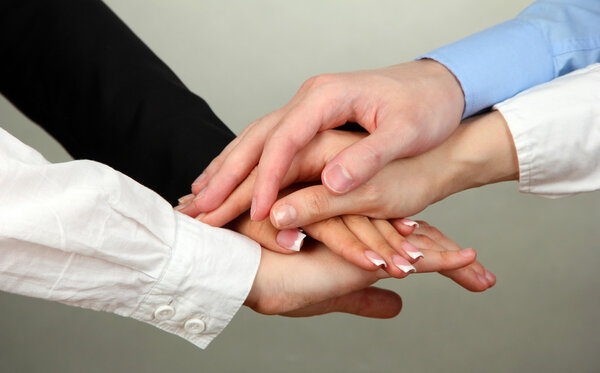 Group of young 's hands on gray background