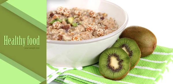 Useful oatmeal in bowl with fruit isolated on white — Stock Photo, Image