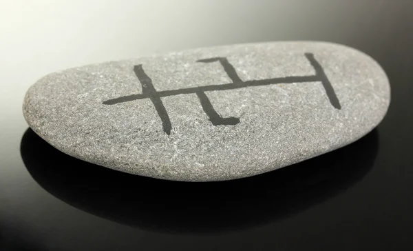 Fortune telling with symbols on stone on black background — Stock Photo, Image