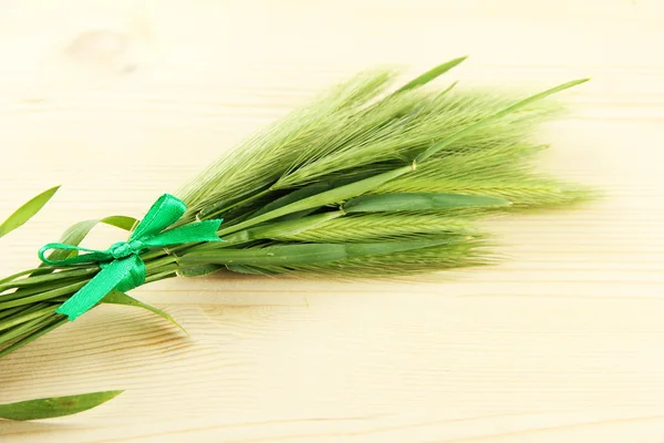 Green spikelets, on wooden background — Stock Photo, Image