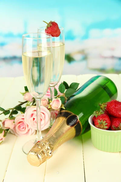 Romantické Zátiší s šampaňským, jahodový a růžové růže, na světlé pozadí — Stock fotografie