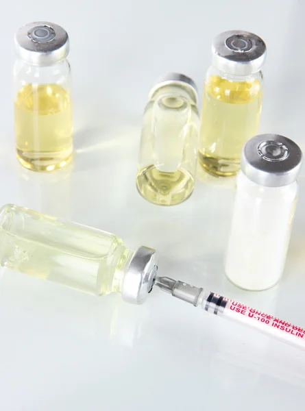 Medical bottles and syringe isolated on white — Stock Photo, Image