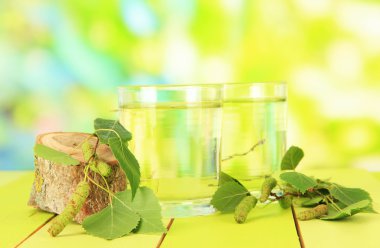 Huş ağacı sap yeşil zemin üzerine ahşap masa üzerinde bardak