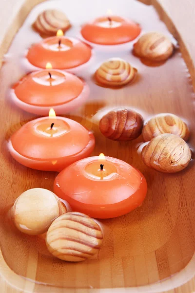 Beautiful candles in water close-up — Stock Photo, Image