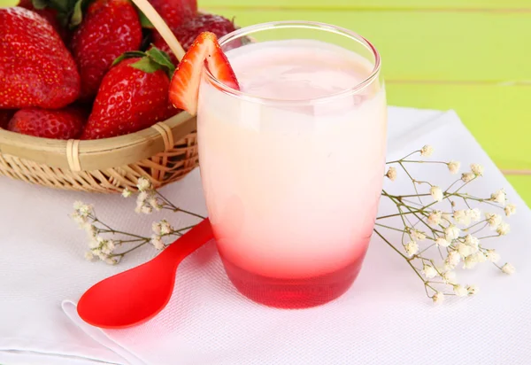 Delicious strawberry yogurt in glass on wooden table close-up — Stock Photo, Image