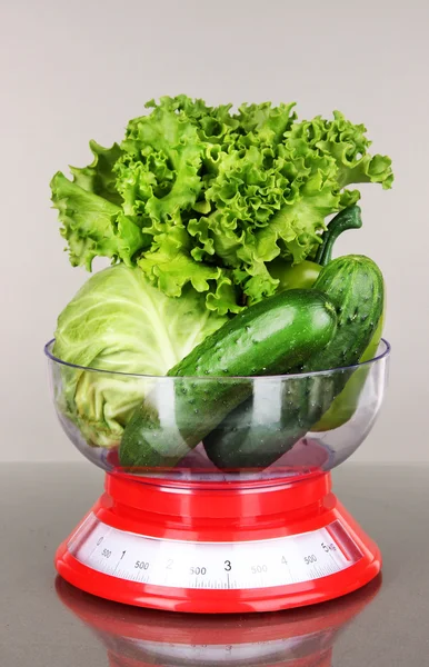 Fresh vegetables in scales on gray background — Stock Photo, Image