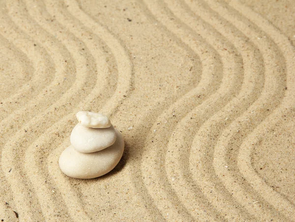 Zen garden with raked sand and round stones close up — Stock Photo, Image