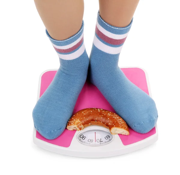 Female feet on scales, isolated on white — Stock Photo, Image