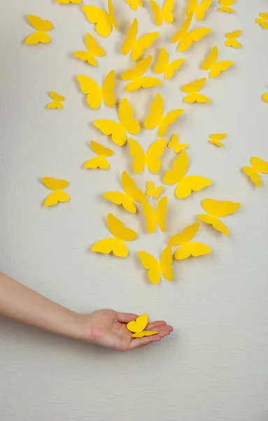 Paper yellow butterflies fly on wall in different directions — Stock Photo, Image