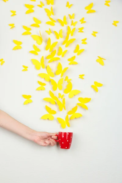 Paper yellow butterflies fly out of cup — Stock Photo, Image