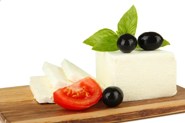 Sheep milk cheese with basil and black olives, tomato on cutting board, isolated on white — Stock Photo, Image