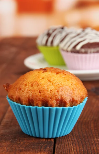 Sweet cupcakes on wooden table — Stock Photo, Image