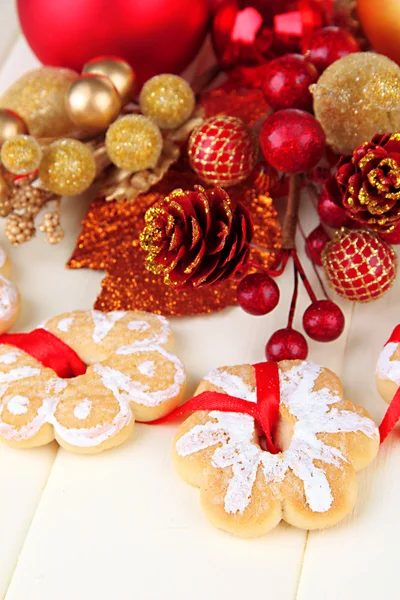 Christmas cookies and decorations on color wooden background — Stock Photo, Image