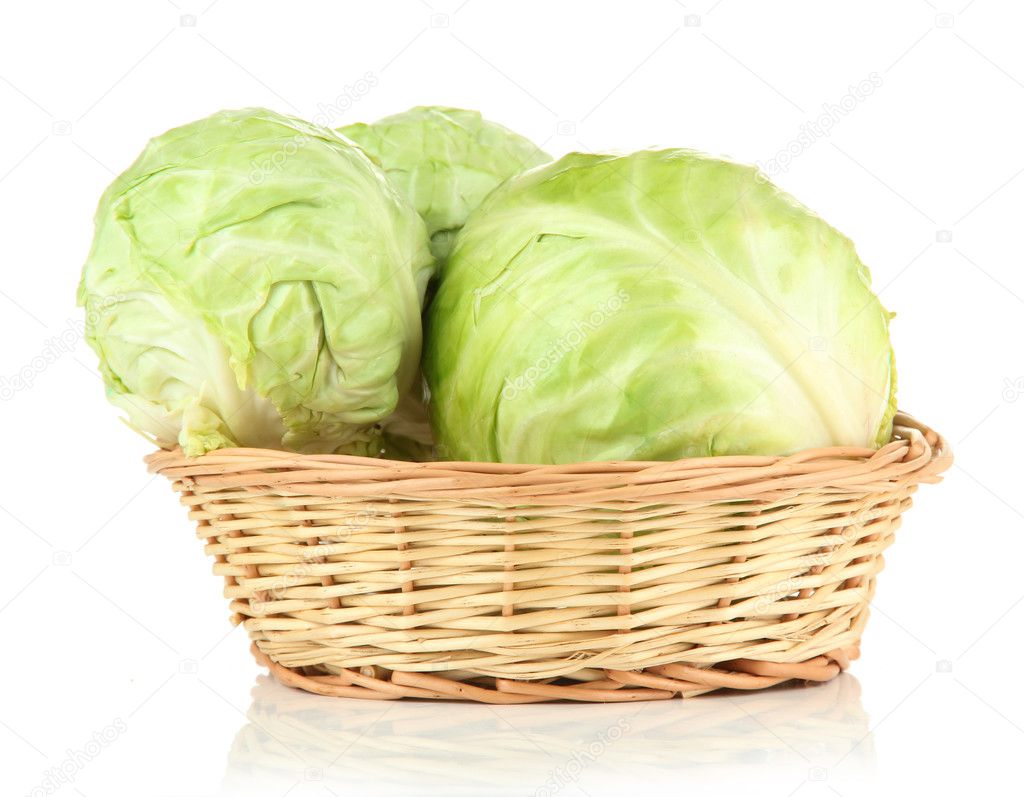Green cabbage in wicker basket, isolated on white
