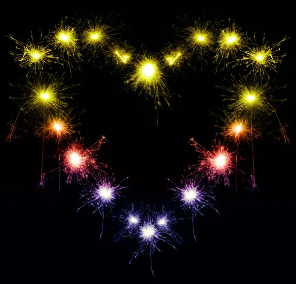 Heart-shaped sparklers on black background — Stock Photo, Image