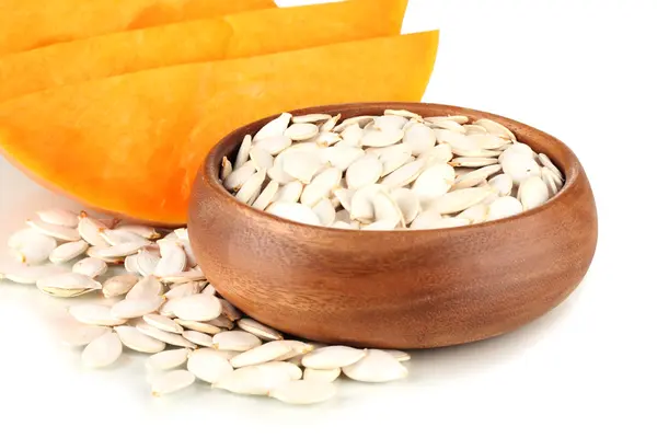 Pumpkin seeds in wooden bowl isolated on the white — Stock Photo, Image